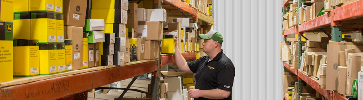 Employee picking out John Deere parts from inventory